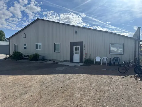 Exterior of the 2091 4th Ave E house with front door, patio chairs and bike rack