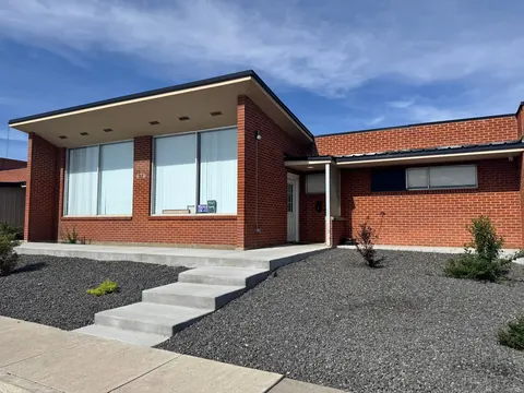Front of the 676 Shoup Ave W house with concrete steps up to the covered entry