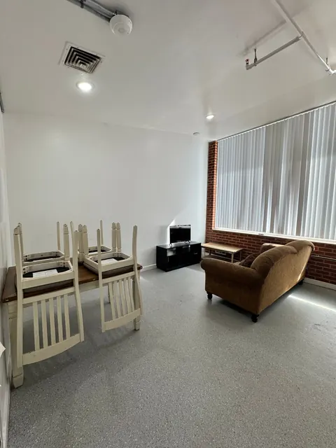 Common room with dining table, sofa and TV at the 676 Shoup Ave W house