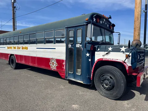 Front three-quarter view of the star-painted Realcovery bus at the 676 Shoup Ave W house